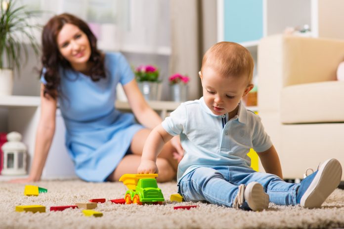 Mother with child playing in the home